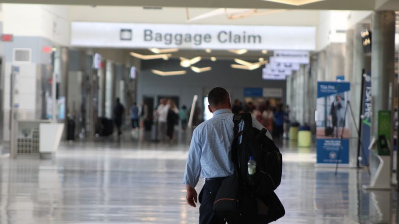 A traveler at the Dayton International Airport on Tuesday, May 23, 2023. CORNELIUS FROLIK / STAFF