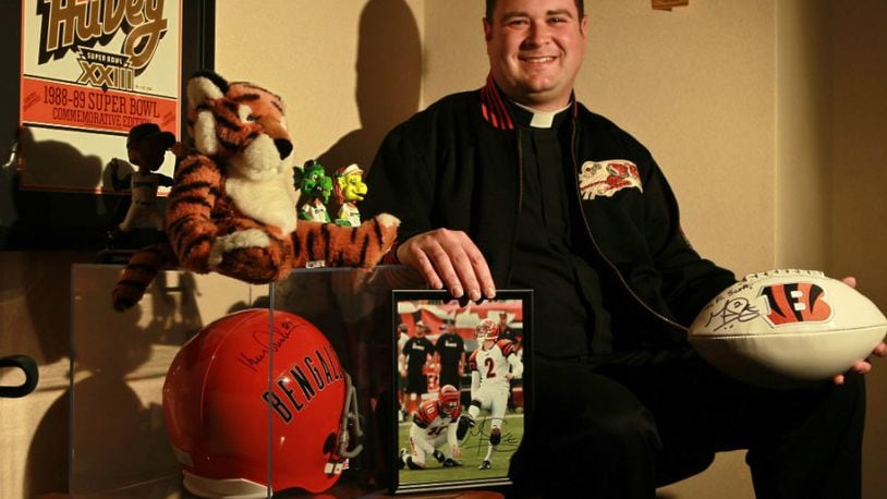 Father Scott Wright, the young priest at Incarnation in Centerville says Mass for -- and counsels -- the Bengals players and coaches the night before games in their team hotel. He is a lifelong Bengals fan, who went to Carroll High School before the seminary. He now is an associate pastor & a teacher at Incarnation, his first-ever parish. He says Mass there wearing Bengals orange and black shoes, has a Bengal tiger in the church's Nativity scene and his office is a museum to Cincy sports with seats from Crosley Field & Riverfront Stadium.