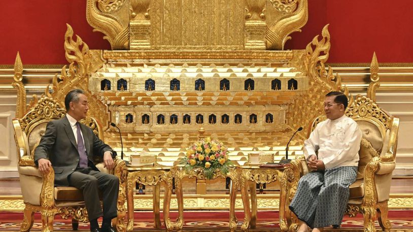 This photo provided by Myanmar Military Information Team, Myanmar's military leader Senior Gen. Min Aung Hlaing, right, chairman of State Administration Council, talks with Chinese Foreign Minister Wang Yi, during their meeting Wednesday, Aug. 14, 2024, in Naypyitaw, Myanmar. (Myanmar Military Information Team via AP)