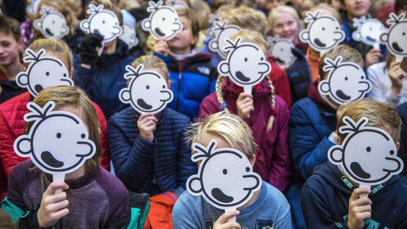 FILE - Children hold up masks of the face of fictional character Greg Heffley during a gathering with the US cartoonist Jeff Kinney, at the publishing house Gyldendal in Oslo, Norway, on Nov. 29, 2018. Norway has tightened controls over adoptions from abroad but will allow the practice to continue as it conducts an investigation into the legality and ethics of past adoptions, the government said Wednesday, June 19, 2024. (Ole Berg-Rusten/NTB scanpix via AP)
