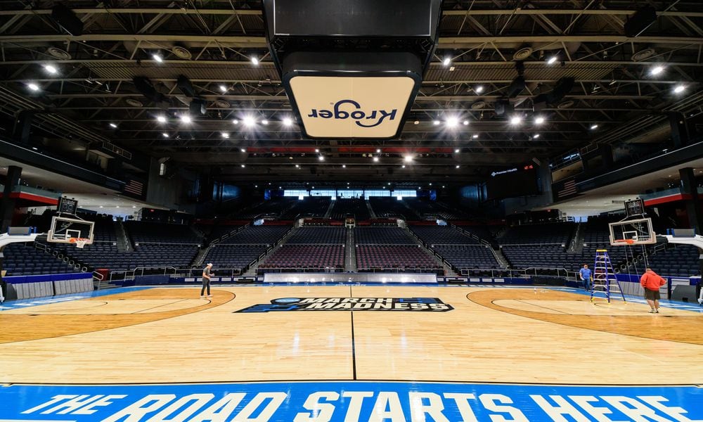 On St. Patrick's Day 2024, workers put the finishing touches on the basketball court installation for the First Four of the NCAA Division I Men’s Basketball Championship at UD Arena which will take place on March 19 & 20, 2024. TOM GILLIAM / CONTRIBUTING PHOTOGRAPHER