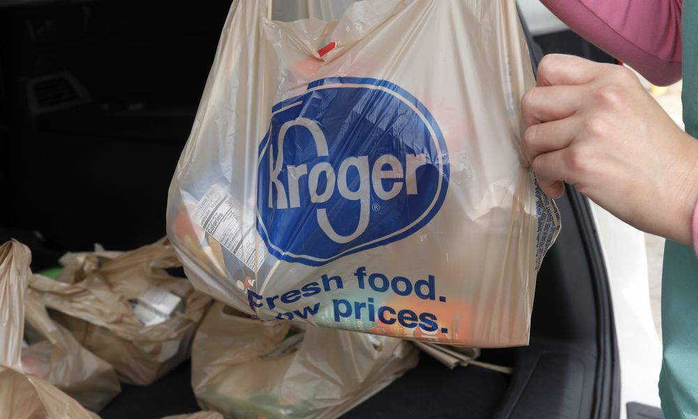 FILE - A customer removes her purchases at a Kroger grocery store in Flowood, Miss., June 26, 2019. Supermarket chains Kroger and Albertsons on Thursday, July 25, 2024, agreed to temporarily halt their proposed merger in Colorado until a judge has considered the states objections. (AP Photo/Rogelio V. Solis, File)