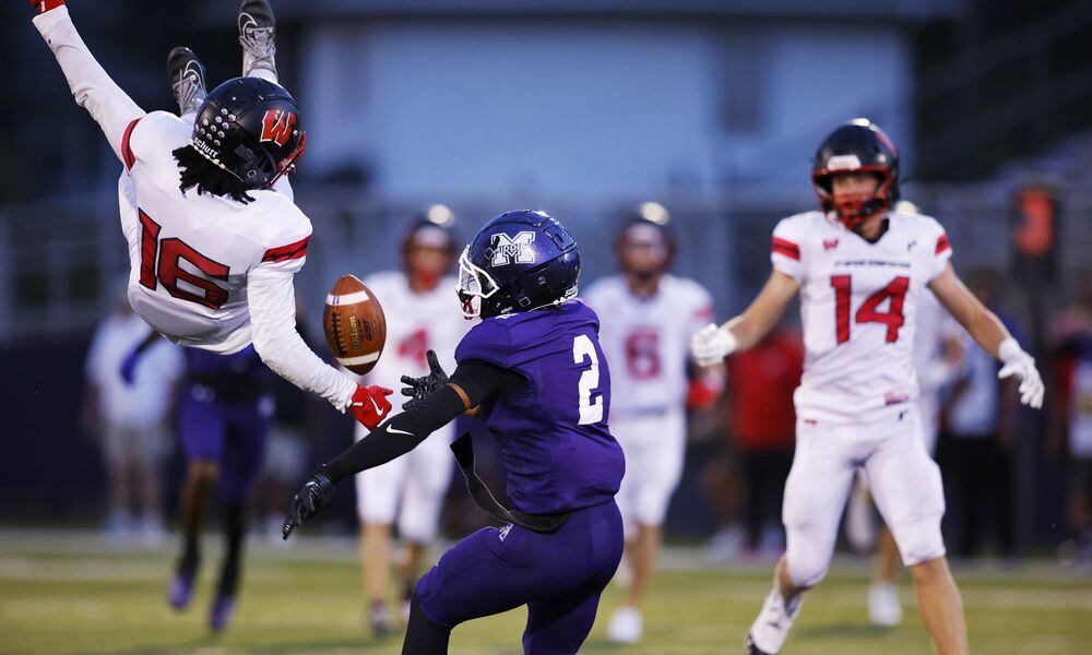 Lakota West's Kolyn Ogletree and Middletown's Maxmillian Johnson (2) vie for the ball during Friday night's game in Middletown. Nick Graham/STAFF