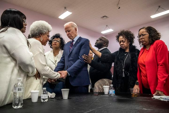 Joe Biden, then a candidate for the Democratic presidential nomination, joins in a prayer before a campaign appearance at Corinthian Baptist Church in Des Moines, Iowa, Jan. 5, 2020. (Brittainy Newman/The New York Times)