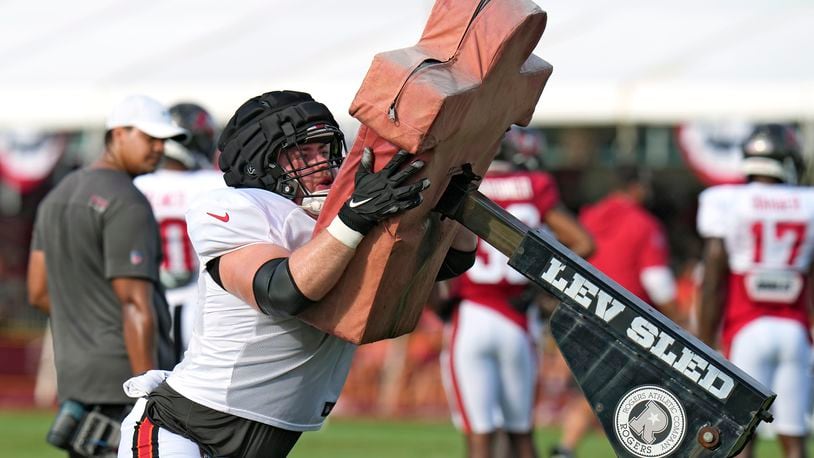 Tampa Bay Buccaneers offensive tackle Michael Niese (68) pushes a blocking sled during an NFL football training camp practice Monday, July 31, 2023, in Tampa, Fla. (AP Photo/Chris O'Meara)