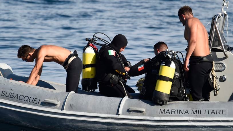 Italian Navy scuba divers work at the scene of the search for a missing boat, in Porticello, southern Italy, Thursday, Aug. 22, 2024. Rescue teams and divers returned to the site of a storm-sunken super yacht to search for one person, who are believed to be still trapped in the hull 50 meters (164-feet) underwater. (AP Photo/Salvatore Cavalli)