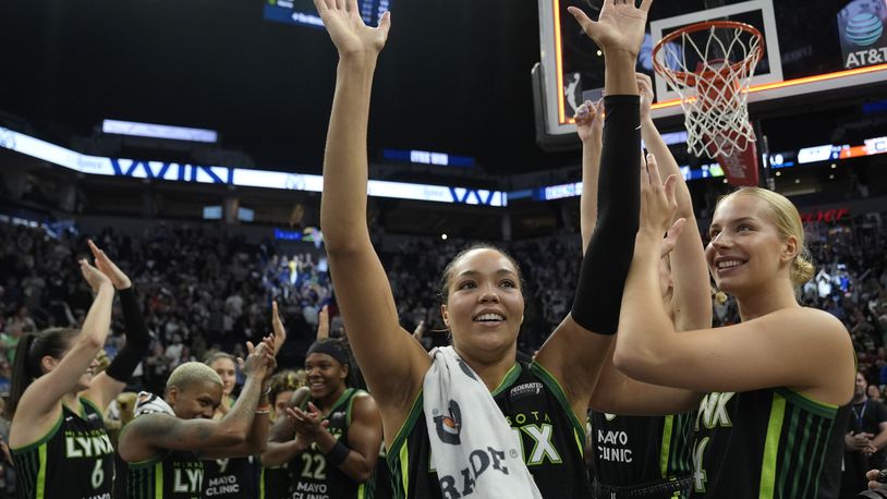 Minnesota Lynx forward Napheesa Collier, center, celebrates with teammates after the 88-77 win against the Connecticut Sun of Game 5 of a WNBA basketball semifinals, Tuesday, Oct. 8, 2024, in Minneapolis. (AP Photo/Abbie Parr)