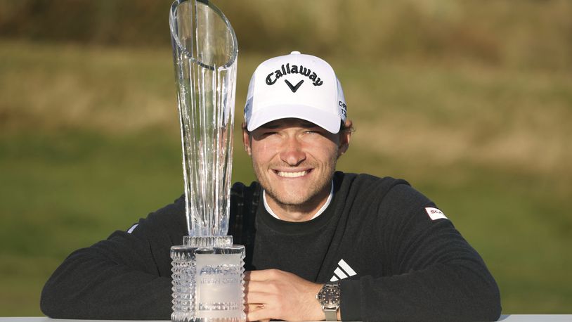 Denmark's Rasmus Hojgaard poses with the trophy after winning the Amgen Irish Open 2024 at Royal County Down in Newcastle, County Down, England, Sunday Sept. 15, 2024. (Peter Morrison/PA via AP)