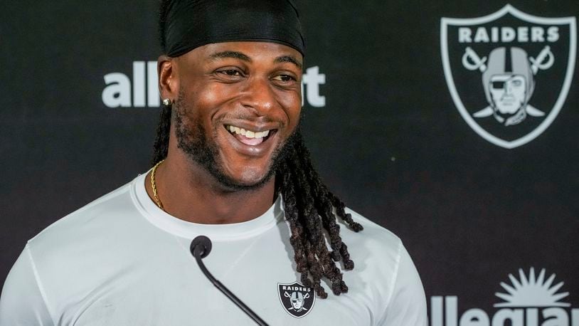 FILE - Las Vegas Raiders wide receiver Davante Adams (17) takes questions from the media after a NFL football training camp at Jack R. Hammett Sports Complex in Costa Mesa, Calif., July 24, 2024. (AP Photo/Damian Dovarganes, File)