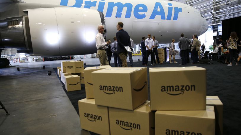 In this Aug. 4, 2016 file photo, Amazon.com boxes are shown stacked near a Boeing 767 Amazon "Prime Air" cargo plane on display in a Boeing hangar in Seattle. (AP Photo/Ted S. Warren)