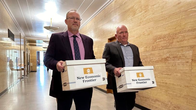 Steve Bakken, left, and Casey Neumann, of the New Economic Frontier ballot initiative group, carry boxes containing petitions to the Secretary of State's Office on Monday, July 8, 2024, at the state Capitol in Bismarck, N.D. Organizers of a ballot initiative to legalize recreational marijuana in North Dakota submitted petition signatures on Monday, likely setting up another statewide vote on the issue that voters and state lawmakers have previously defeated. The group submitted more than 22,000 signatures, sponsoring committee chairman Bakken said. (AP Photo/Jack Dura)