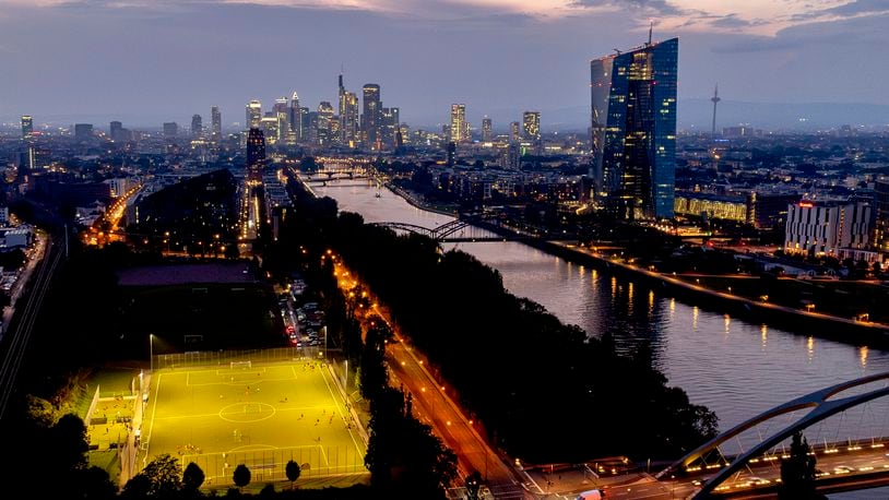 FILE - The European Central Bank stands at right as soccer players practise on a field next to the river Main, in Frankfurt, Germany, late Thursday, Sept. 19, 2024. (AP Photo/Michael Probst, File)