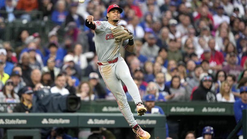 Cincinnati Reds third baseman Santiago Espinal throws out Chicago Cubs' Pete Crow-Armstrong at first during the sixth inning of a baseball game Saturday, Sept. 28, 2024, in Chicago. (AP Photo/Charles Rex Arbogast)