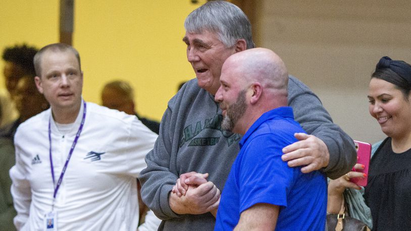 Chaminade Julienne head coach Charlie Szabo (right) is congratulated by former Eagles head coach Joe Staley after CJ's 64-59 victory over Alter in the Division II region final Saturday night at Butler High School. CONTRIBUTED/Jeff Gilbert