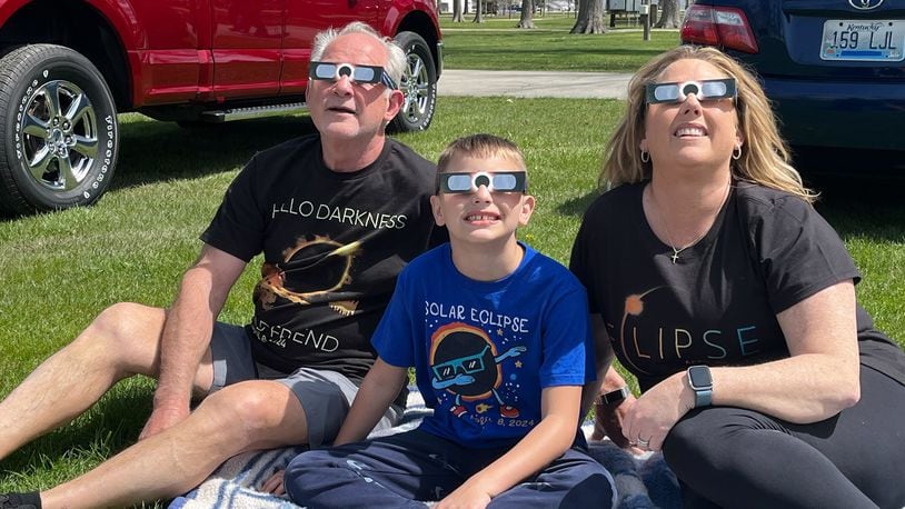 Anthony, left, and Tammy Stratton, right of Lawrenceburg, Kentucky watch the eclipse Monday, April 8 with their grandson Eli Brock of Liberty Twp. at the Darke County Fairgrounds. RICH GILLETTE/STAFF PHOTO