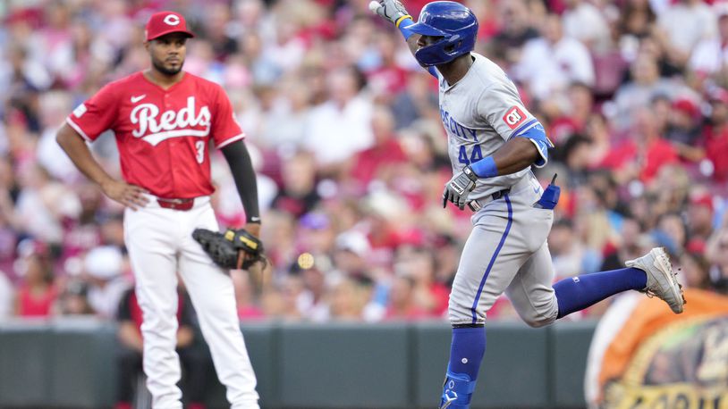 Cincinnati Reds first baseman Jeimer Candelario (3) looks on as Kansas City Royals' Dairon Blanco (44) rounds the bases after hitting a grand slam in the third inning of a baseball game in Cincinnati, Saturday, Aug. 17, 2024. (AP Photo/Jeff Dean)