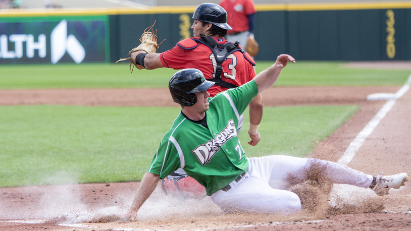 Jacob Hurtubise, on a minor-league rehab assignment from Louisville, is safe at home on a double steal as Cedar Rapids catcher Nate Baez sees that the throw is late. Jeff Gilbert/CONTRIBUTED