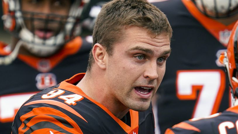 FILE - Cincinnati Bengals defensive end Sam Hubbard (94) talks with a teammate before an NFL football game against the Dallas Cowboys in Cincinnati, in this Sunday, Dec. 13, 2020, file photo. The Bengals on Monday, July 26, 2021, announced a four-year contract extension for Hubbard.(AP Photo/Bryan Woolston, File)