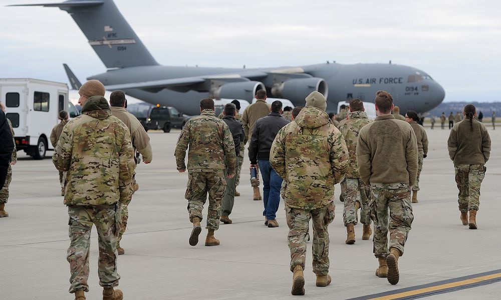Airmen walk out Thursday, Jan. 4, 2024 to greet a C-17 Globemaster cargo plane, the Airmen returned to Wright-Patterson Air Force Base from more than two months deployed at an undisclosed location. MARSHALL GORBY\STAFF
