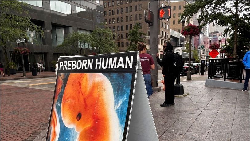 A volunteer with the anti-abortion group Created Equal talks to a member of the public near the Ohio Statehouse Friday, June 23. Created Equal routinely holds events near the Statehouse to push for abortion restrictions, including after the U.S. Supreme Court overturned Roe v. Wade.