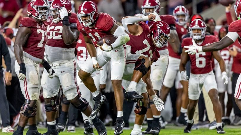 Alabama linebacker Jihaad Campbell and offensive lineman Parker Brailsford celebrates after Campbell's interception during the first half of an NCAA college football game against Georgia, Saturday, Sept. 28, 2024, in Tuscaloosa, Ala. (AP Photo/Vasha Hunt)