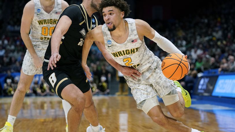 Wright State guard Tanner Holden (2) drives past Bryant's Luis Hurtado (10) during the second half of a First Four game in the NCAA men's college basketball tournament, Wednesday, March 16, 2022, in Dayton, Ohio. (AP Photo/Jeff Dean)