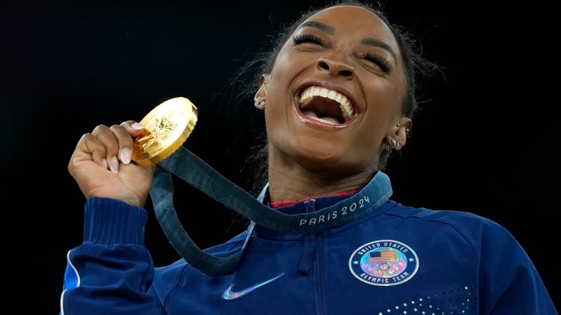 FILE - Simone Biles, of the United States, celebrates winning the gold medal during the medal ceremony in the women's artistic gymnastics individual vault finals at Bercy Arena at the 2024 Summer Olympics, Aug. 3, 2024, in Paris, France. (AP Photo/Francisco Seco, File)