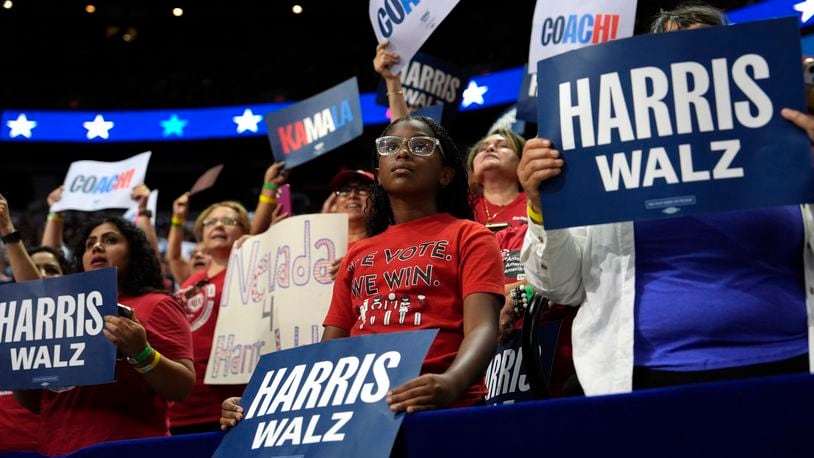 FILE - Supporters carry signs as Democratic presidential nominee Vice President Kamala Harris speaks at a campaign rally, Saturday, Aug. 10, 2024, in Las Vegas. (AP Photo/Julia Nikhinson, File)