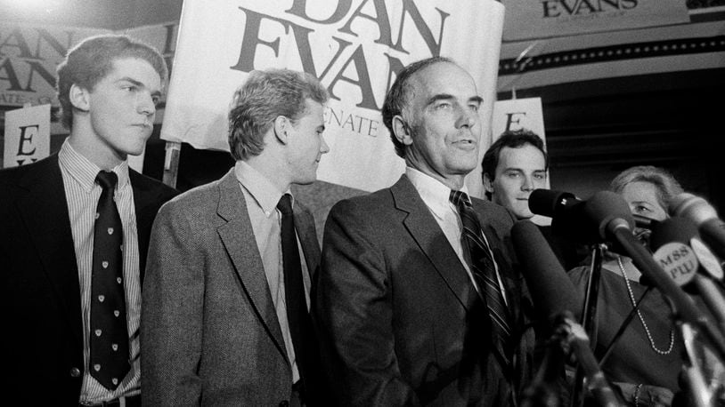 Sen. Dan Evans stands with his three sons, from left, Mark, Bruce and Dan Jr., after he won the election for Washington's senate seat in Seattle, Nov. 8, 1983. (AP Photo/Barry Sweet, File)